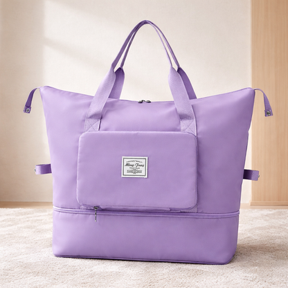 bagage cabine femme violet extensible et pliable sur tapis crème ambiance zen avec poignées roses mises en avant et séparation pratique humide et sec