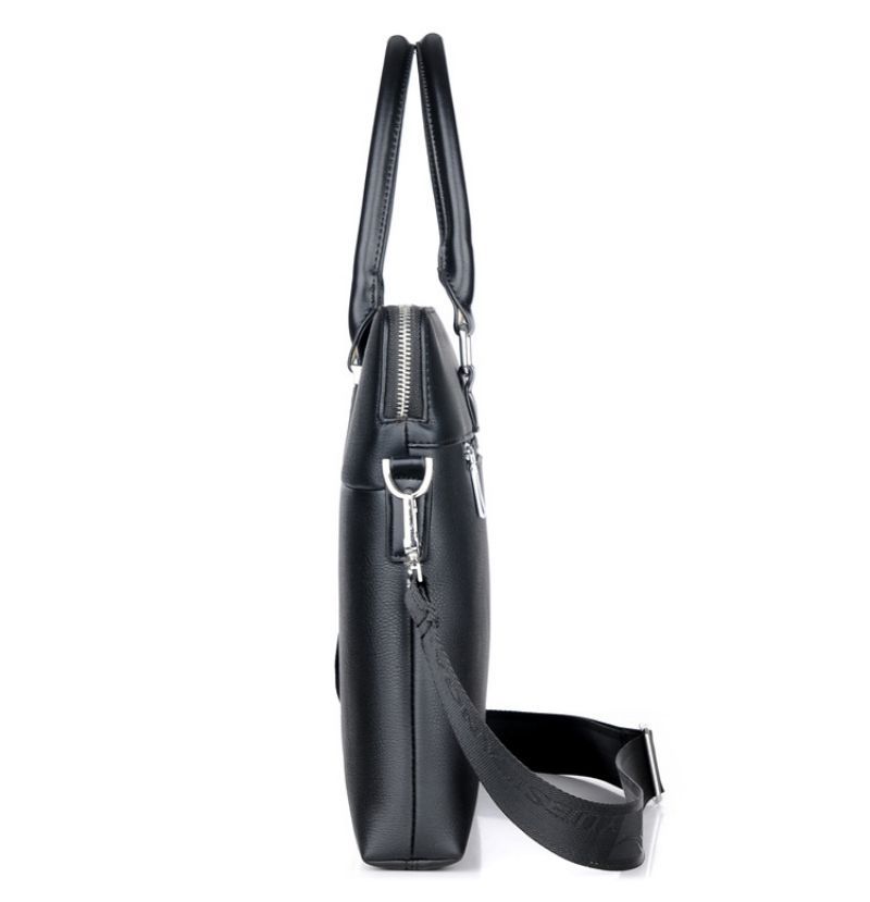 Sacoche ordinateur homme noire photographiée de côté, mettant en valeur la fermeture éclair, la bandoulière et le format compact.