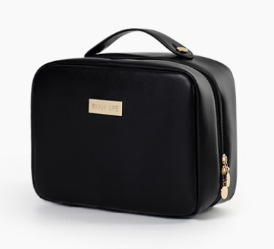 Trousse de toilette femme noire élégante avec fermeture zippée et poignée, présentée sur fond blanc, idéale pour le rangement des produits de toilette et maquillage.