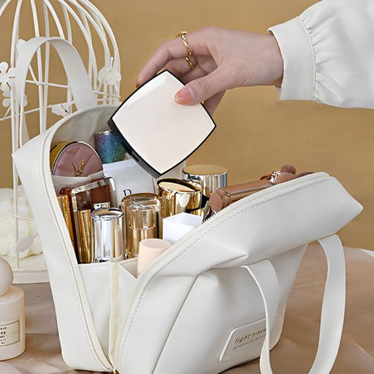 trousse maquillage blanche ouverte pour présenter la possibilité de stockage de produits indispensable pour les vacances